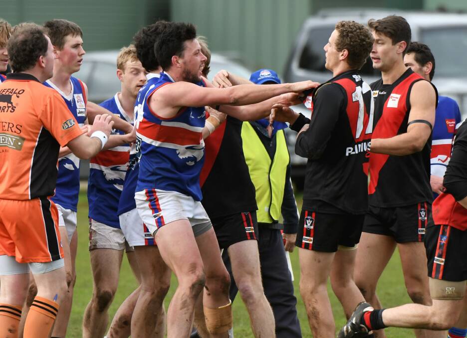 PUSH AND SHOVE: Daylesford's Sam Winnard and Buninyong's Lachlan Baker during a heated moment at Learmonth.