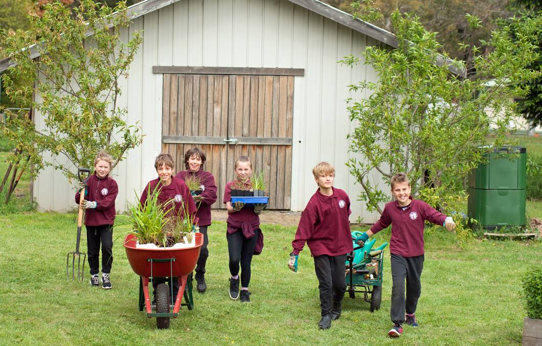 PLANTING: Lulu, Ari, Coen, Arabella, Manu and Val prepare to plant the Basalt Peppercress plant at Trentham and District Primary School. Photo: Sandy Scheltema

