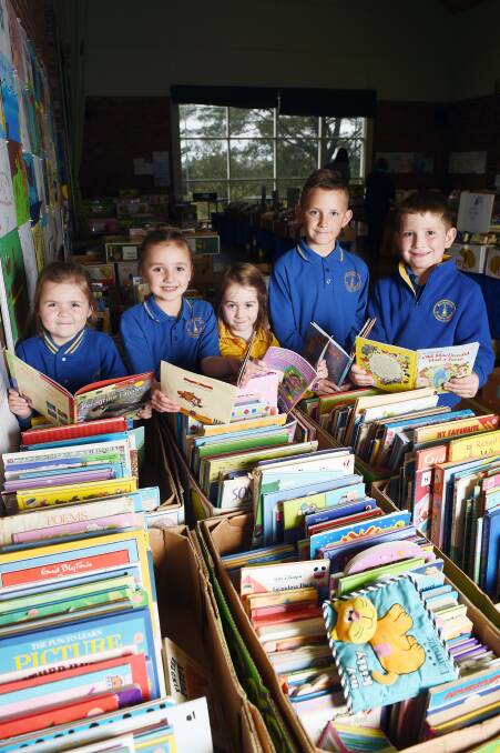 BOOKS GALORE: Daylesford Primary School's year one students Claudia and Lilly, with prep Chloe, year five student Aaro and year one student Ethan. Photo: Kate Healy
