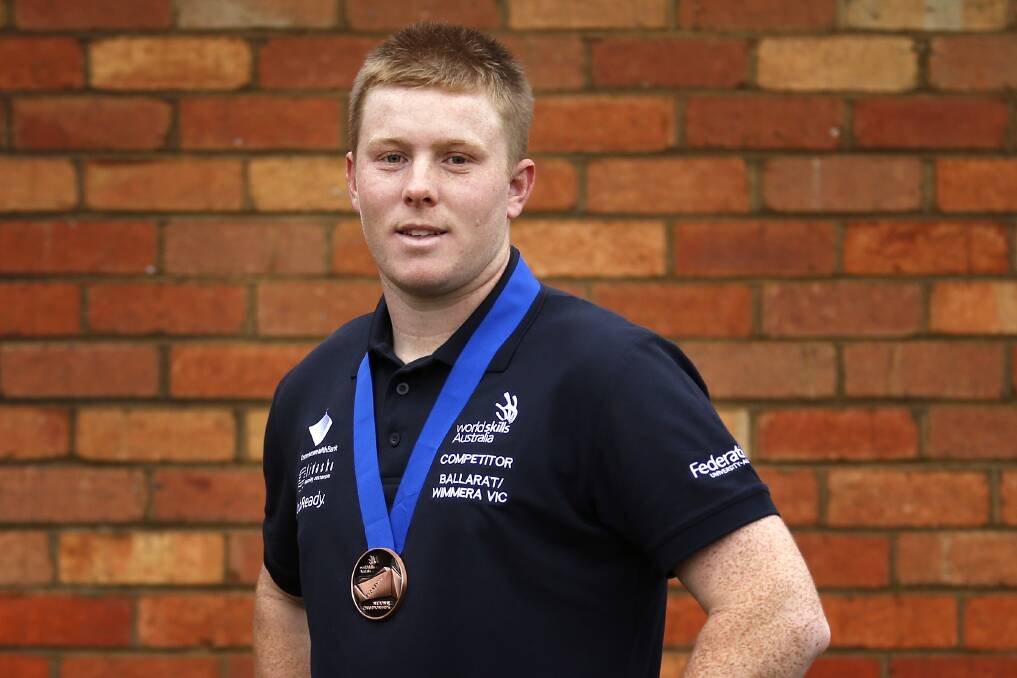 WINNER: Paul Coon, 20, of Clunes, was awarded the bronze medal in bricklaying at the 2018 Worldskills championships in Sydney last week. He hopes to be chosen to represent Australia in Russia next year. Photo: Dylan Burns
