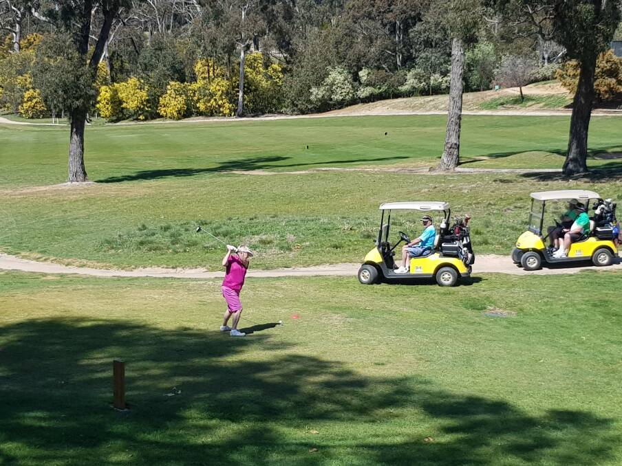 TEE OFF: Sue Curnow competing in the event, watched by Don Curnow, Rob Rosenow and Peter Wilkes.