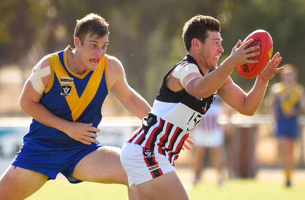 TACKLE: Learmonth's Matthew Willox pursues Creswick's Aaron Sedgwick during round two of the Central Highlands Football League at Learmonth. Photo: Adam Trafford