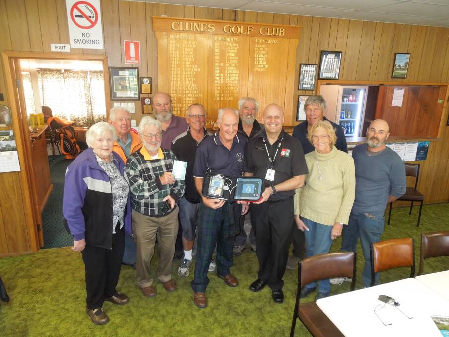 Clunes Golf Club members with club president Ray Skinner and St John Ambulance trainer Jonathan Barge and the defibrillator.