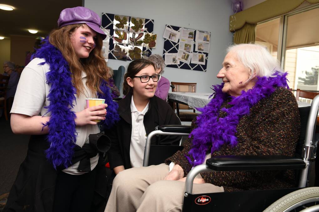 PURPLE: Daylesford Secondary College year seven students Isobella Campbell-Smith and Danielle Baldovino, with Hepburn House resident Florence Craigie. Photo: Kate Healy 
