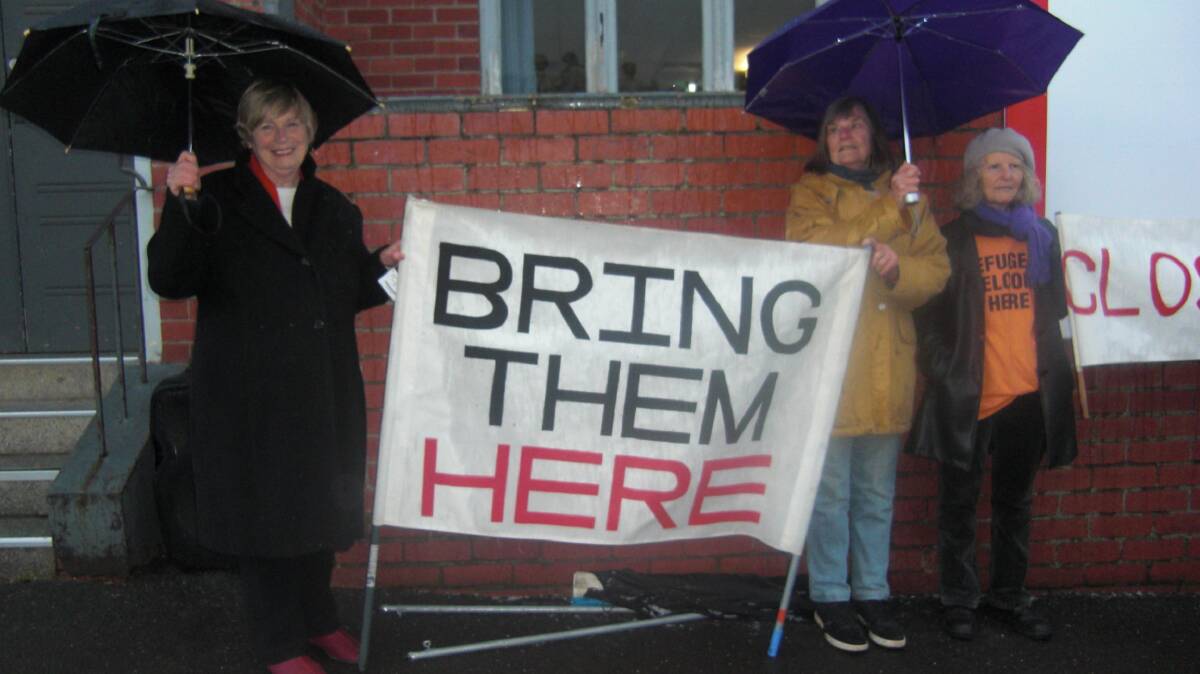 RAINY VIGIL: Daylesford and District's Rural Australians for Refugees Group members hold a vigil in wet weather last Thursday afternoon to remember refugees. 