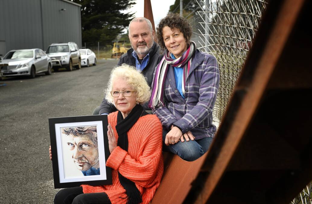 HONOUR: Trentham's Jacinta Burke, David Bryant and Janine Bryant with a painting of their late friend Matthew Harding. Photo: Dylan Burns