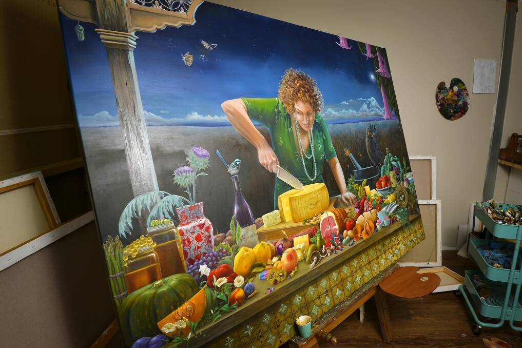 WHAT A FEAST: Trentham artist Llael MacDonald has been working on her painting, 'Lisa's Feast' for the last 12 months. The painting features her friend Lisa Marmur on a verandah overlooking a grassy field. Picture: Dylan Burns