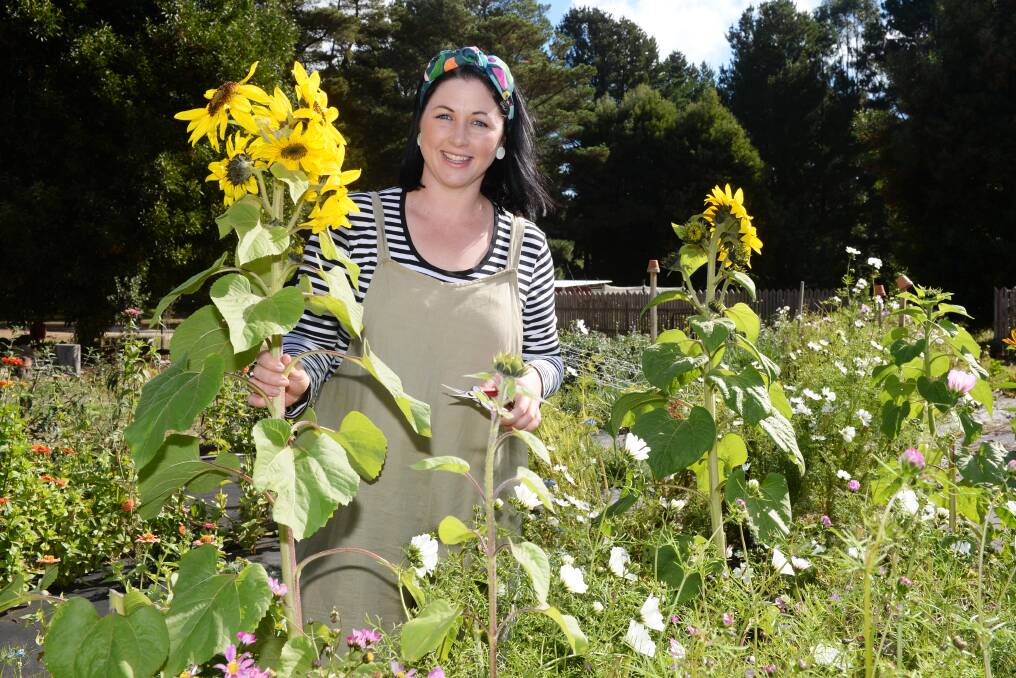 BRIGHT: Janae Paquin-Bowden among the sunflowers at her flower farm Fleurs de Lyonville. Photo: Kate Healy