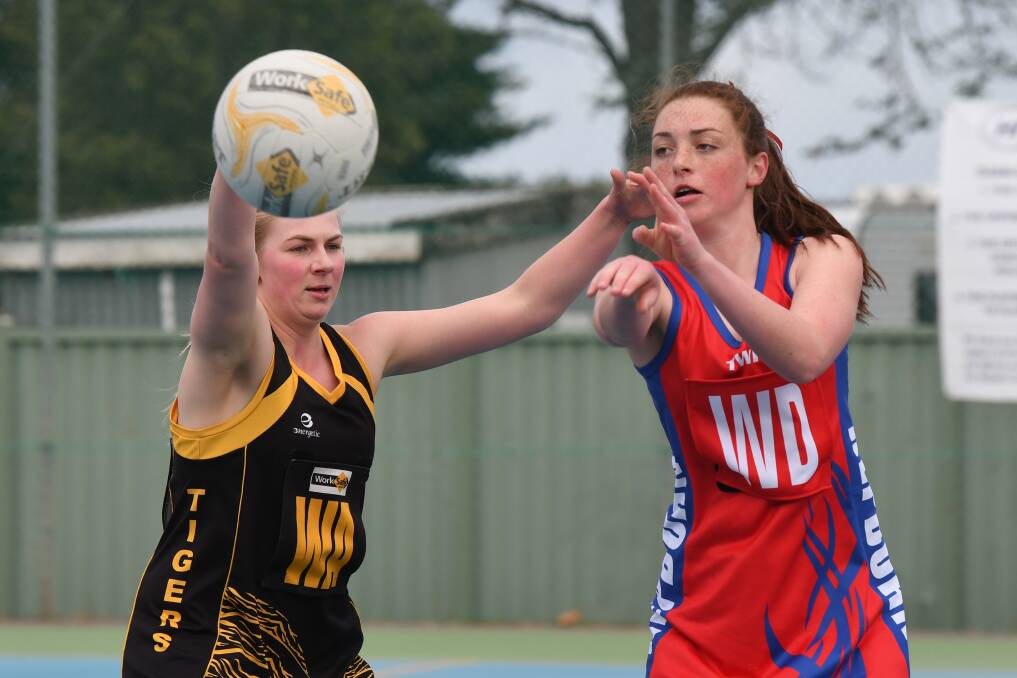 PLAY: Springbank's Thea Hinchliffe defends Hepburn's Brydi Hutchinson as she tries to catch the ball. Photo: Kate Healy