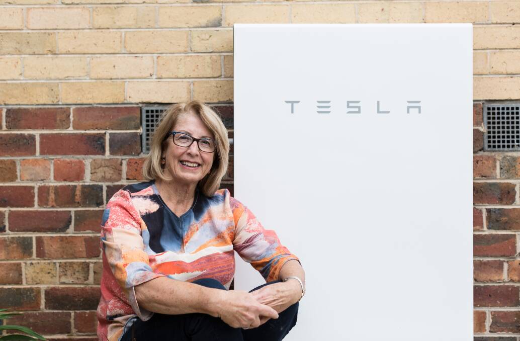 BATTERY: Jo Maher with her Tesla battery purchased through the Hepburn community solar bulk buy.

