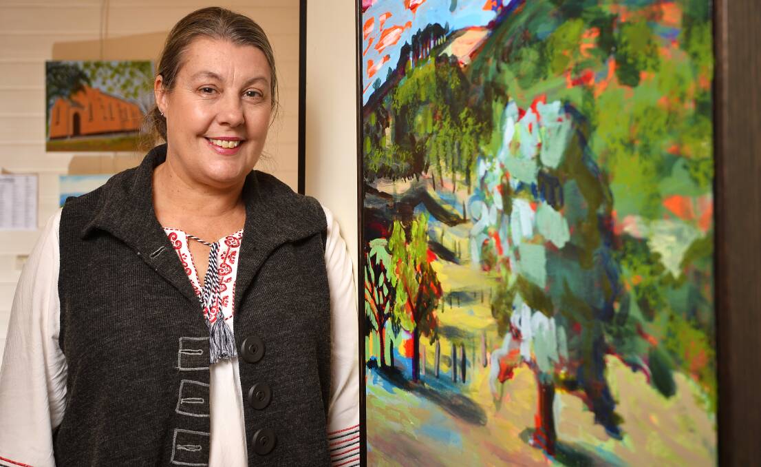 FIRST PRIZE: Artist Sandra Angliss, of Porcupine Ridge, with her vibrantly hued painting of her property, titled "Porcupine Delight". Photo: Dylan Burns