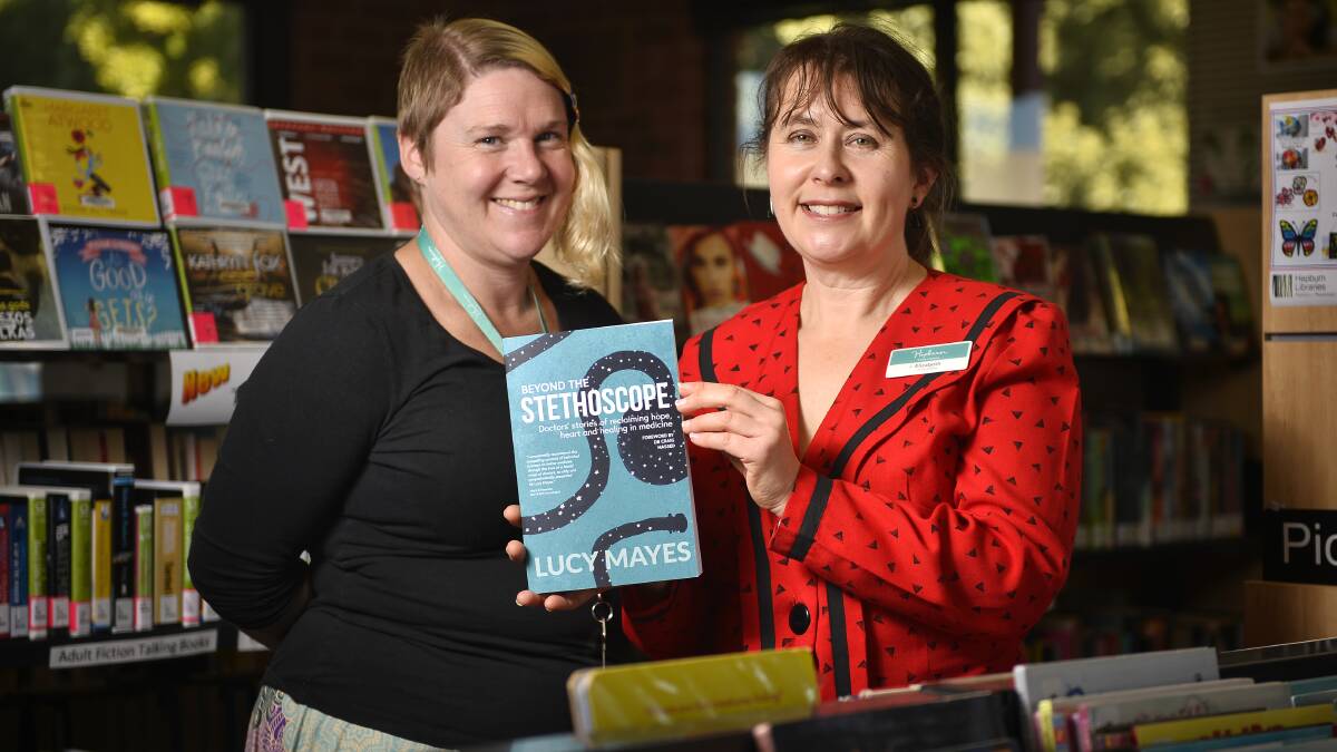 GET READING: Librarians Allison Hadfield and Elizabeth Wells with guest speaker Lucy Mayes' book Beyond the Stethoscope. Photo: Dylan Burns