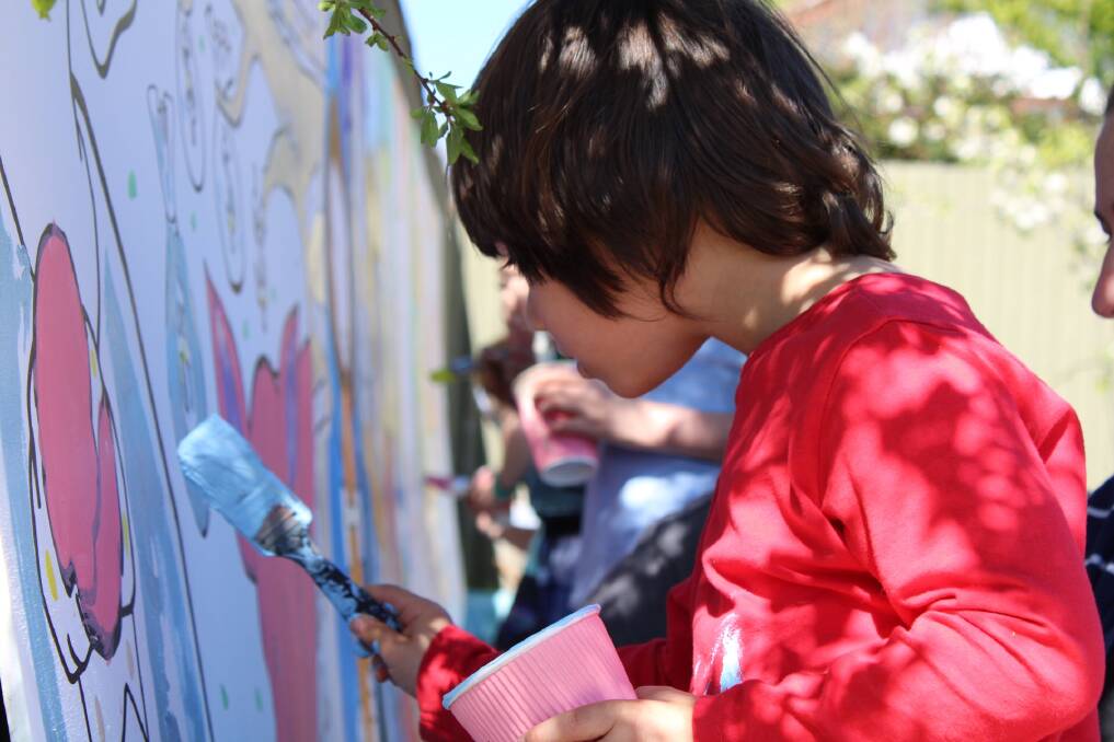 CONCENTRATING: Five-year-old Oscar enjoyed painting the mural. Photo: Hayley Elg