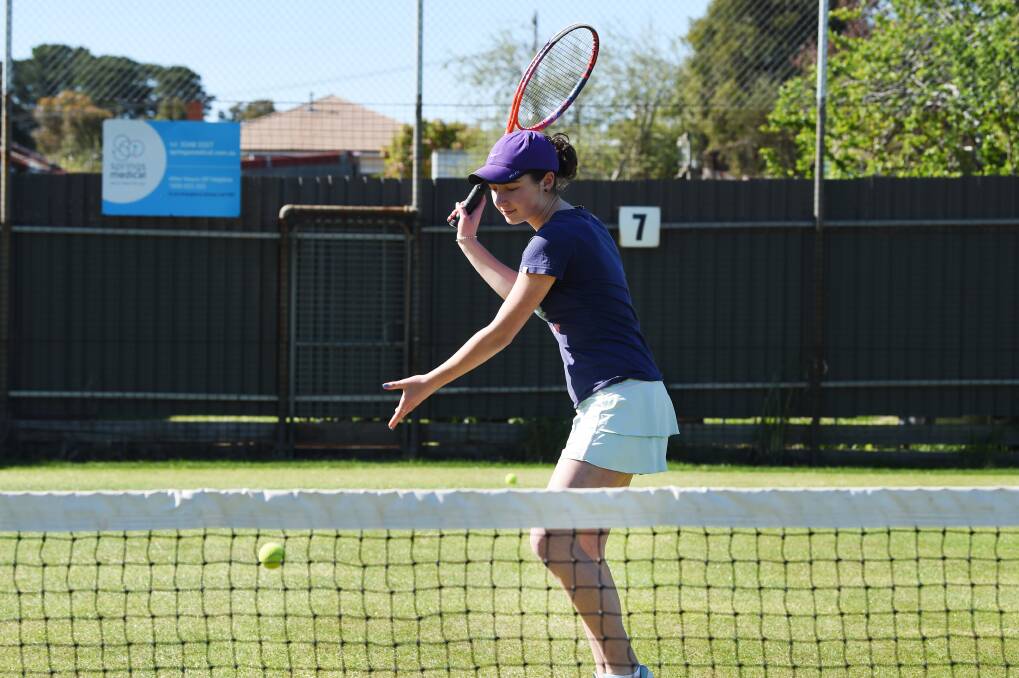 HIT: Anna Santurini enjoys the grass tennis courts at Daylesford Lawn Tennis Club, where she learnt the game she has come to love. Photo: Kate Healy