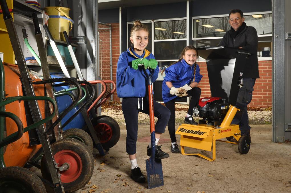 SHREDDER: Daylesford Primary School's nine-year-old pupils Sierra and Matisse with Adsum Farm's Edward Benedict, who donated the shredder with profits made at the Gardens of Glenlyon event this year. Photo: Dylan Burns