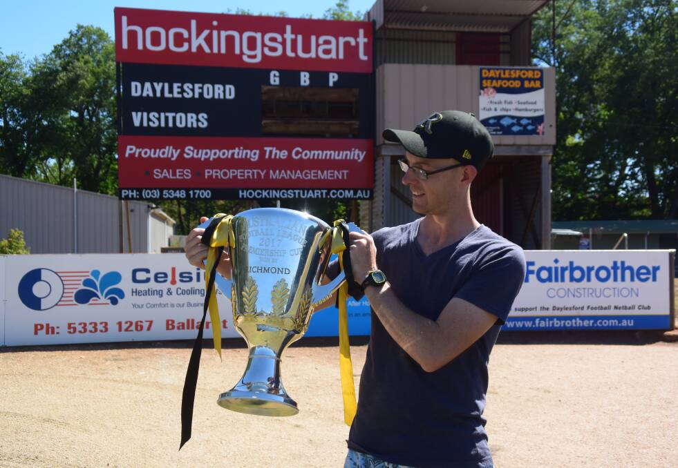 STILL CELEBRATING PREMIERSHIP GLORY: Daylesford local and Richmond Football Club's myotherapist and head trainer, Matt Pearce, with the 2017 AFL premiership cup at Daylesford Football Club at Victoria Park. Photo: Hayley Elg