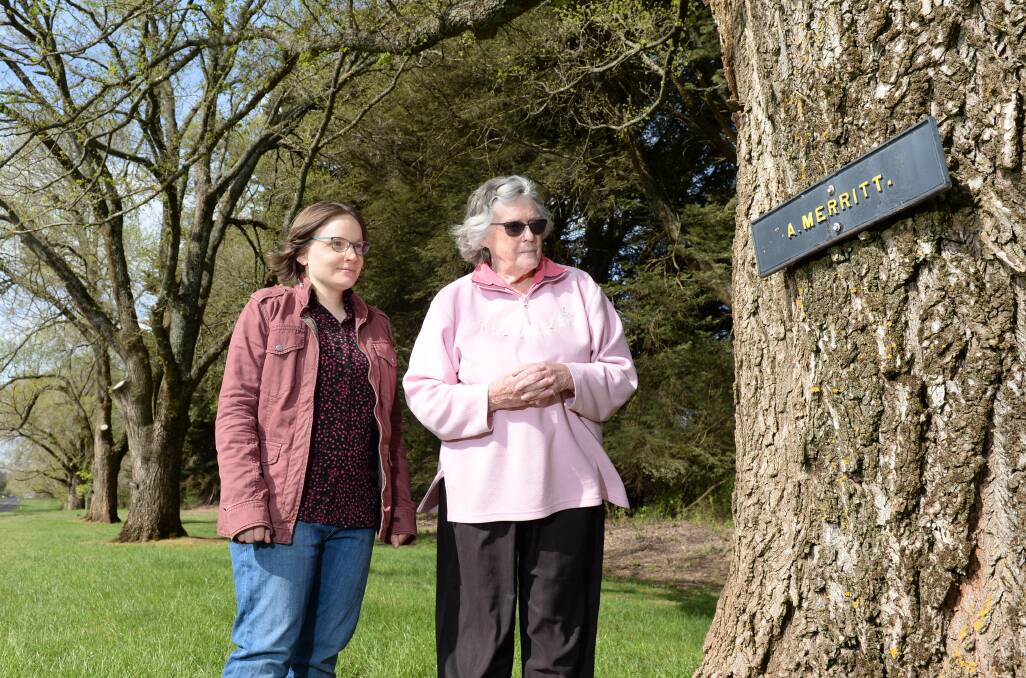 AVENUE OF HONOUR: Leah Armstrong and Evelyn Wright with the tree commemorating Arthur Merritt. Photo: Kate Healy

