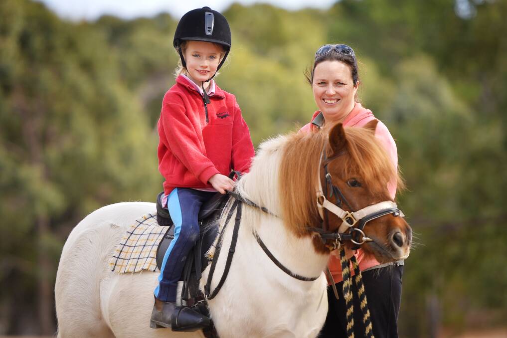 HORSING AROUND: Former members of the Kingston & District Pony Club, Alicia Fraser, her daughter Ellie and their pony, Red.  Photo: Dylan Burns