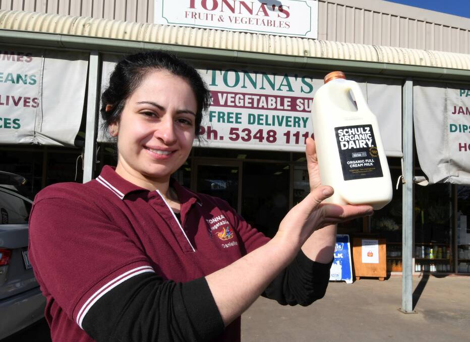 OLD SCHOOL: Danielle Tonna of Tonna's Fruit and Vegetables in Daylesford with the current Schulz Organic Dairy milk bottle. Photo: Lachlan Bence