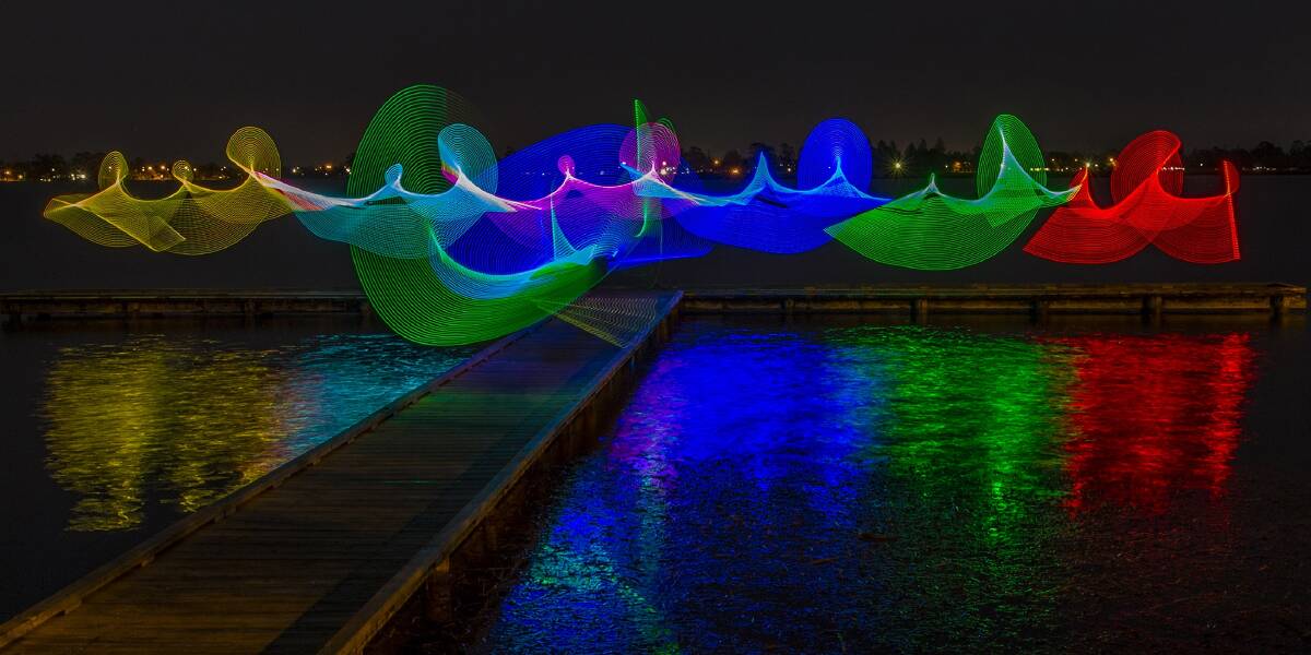 RAINBOW: Ballarat Light Painters create a multicoloured rainbow of light on the end of a jetty in Lake Wendouree using a combination of LED lights and camera know-how to paint a picture. Pictures: Lindsay Brown 