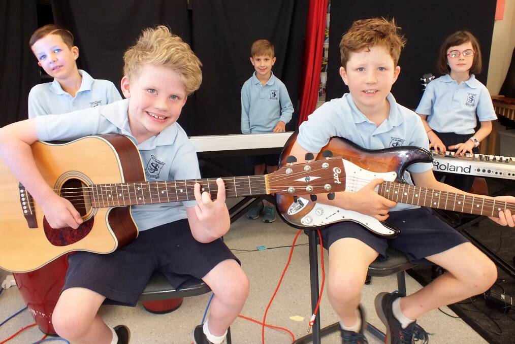 ROCKERS: Junior musicians Archer, Daniel, Jude, Mason and Indianna rehearse their concert performance for the St James' Parish School Arts Festival this week. 