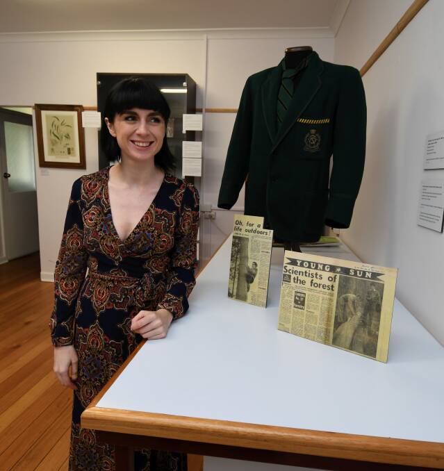 FOREST HISTORY: Curator Tahney Fosclike shows off some of the collection displayed in The School on the Hill exhibition showcasing the history of Creswick's Victorian School of Forestry. Picture: Lachlan Bence