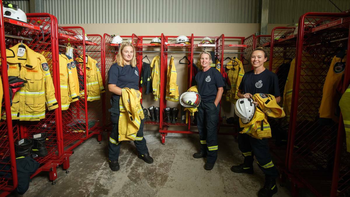Volunteer firefighters Jet Boone, Lise Percival and Samantha Walker gear up in the Bawley Point Rural Fire Brigade's shed. The brigade has 18 female members. Picture: Sitthixay Ditthavong