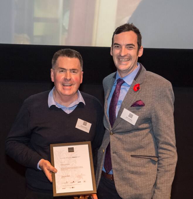 Daylesford and District Historical Society volunteer Gary Lawrence accepts his Museums Australia award from Shrine of Remembrance exhibitions curator Neil Sharkey at the Australian Centre for Moving Images (ACMI) on Wednesday night. Picture: Simon Fox. 