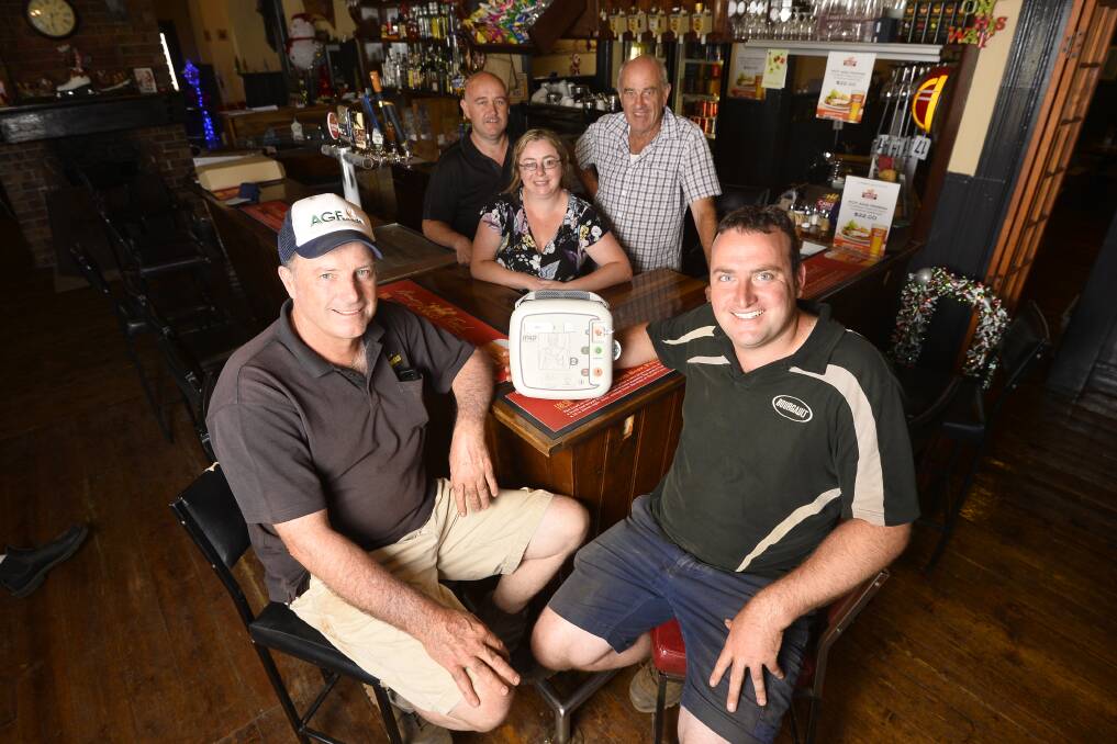 SAVING LIVES: Cumberland Hotel owners Amanda Bomphrey and Troy Bomphrey with Smeaton CFA members David Toose, Tom Toose and Ron Cosgrave and the station's new defibrillator. Picture: Dylan Burns