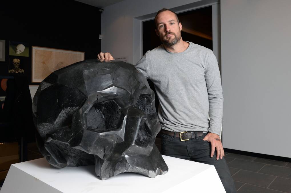 SKULL: Hepburn Springs artist Josh Bowes exhibits his black basalt skull at the Art Gallery of Ballarat. It is part of the Romancing the Skull major exhibition which explores the depiction of the skull in art. Picture: Kate Healy