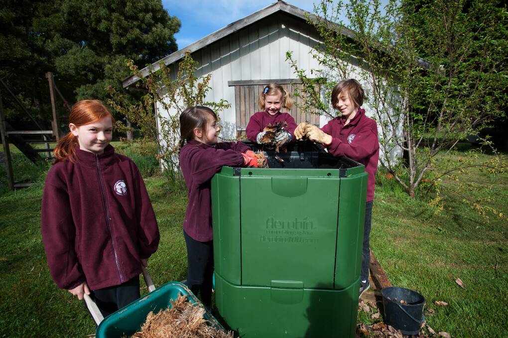 GREENIES: Trentham and District Primary School pupils Neallah, Arrabella, Calista, and Xavier learn how to make good compost with their new large compost bin in the kitchen garden. Picture: Sandy Scheltema