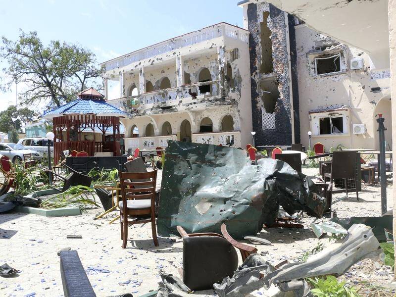 A car bomb has exploded and gunmen have stormed a hotel in Kismayo, Somalia, killing 26 people.