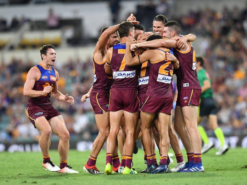 Brisbane celebrated a 44-point home win over premiers West Coast in round one of the AFL.