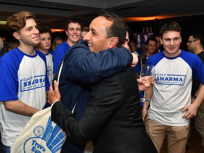 Liberal candidate Dave Sharma (C) is vying to reclaim the Sydney seat of Wentworth.