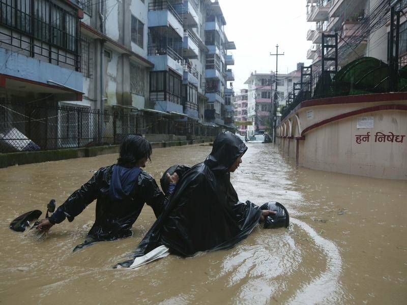Heavy monsoon rains in Nepal have set off landslides and flash floods, killing at least 30 people.