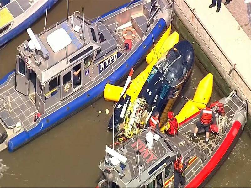 The helicopter was hauled out of the water by a marine crane after about 90 minutes in the Hudson.