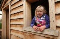 Astrid Kronberger, 7, checks out a log cabin in the Creswick Magic Pudding Playground. Picture: Adam Trafford
