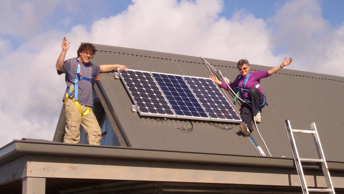BE AWARE: Anneke Deutsch, right, with her solar panels and installer David Grigg. Picture: CONTRIBUTED